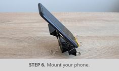 an image of a cell phone holder attached to a wooden table with text that reads step 6 mount your phone