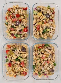 four plastic containers filled with pasta salads