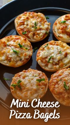 mini cheese pizza bagels on a black plate