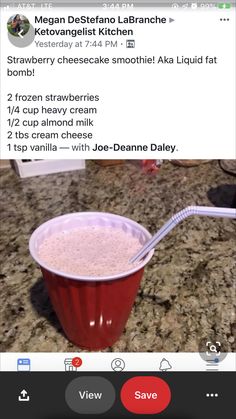 a red cup filled with ice cream sitting on top of a counter