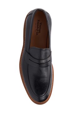 A classic penny keeper distinguishes this leather loafer for a timeless well-dressed staple. Lace-up style Cushioned insole Leather upper/leather and textile lining/rubber soe Imported Vintage Slip-on Loafers For Work, Retro Leather Loafers For Work, Classic Cap Toe Loafers With Branded Insole, Retro Leather Sole Loafers For Work, Vintage Moc Toe Dress Shoes For Semi-formal Occasions, Vintage Black Oxfords With Leather Footbed, Retro Oxfords With Rubber Sole For Work, Retro Leather Sole Loafers With Round Toe, Retro Leather Slip-on Loafers