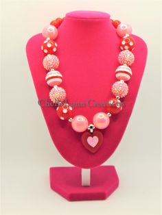 "-  Pretty red and pink Valentine necklace with 20mm and 12mm sparkle chunky beads with silver spacers. 1.5\" red heart centerpiece -  Your little girl or toddler will look like a Princess in this beautiful, fun, Chunky Bubblegum Necklace. -  This necklace would be the perfect dazzling addition for your little Princess outfit to wear for any special occasion. -  Necklace length 17\"  Materials:  acrylic beads, resin beads, bead wire, crimp tubes, stainless steel jump rings, stainless steel clasps **Custom Orders Are Welcome** Ready to ship in 1 to 3 business days by USPS First Class Mail. - Returns & Exchanges I do accept returns and exchanges.  Just mail it back to me within 7 days of delivery. WARNING The jewelry is made with small beads and small parts.   Please do not leave your child Cute Red Necklace For Parties, Playful Pink Necklace For Valentine's Day, Red Necklace For Valentine's Day Birthday, Red Necklace For Birthday And Valentine's Day, Playful Pink Beaded Necklaces For Birthday, Playful Pink Beaded Necklaces For Birthdays, Playful Pink Beaded Necklace For Birthday, Playful Red Jewelry For Birthday, Cute Pink Beaded Necklaces For Birthday