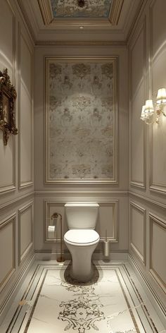 a white toilet sitting inside of a bathroom next to a chandelier and lights