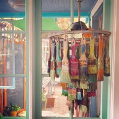 there are many colorful items hanging from the ceiling in this shop front window, and on display