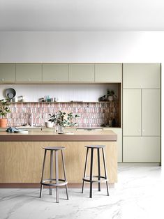 two stools are in front of the kitchen counter