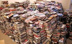 a large pile of dvds stacked on top of each other