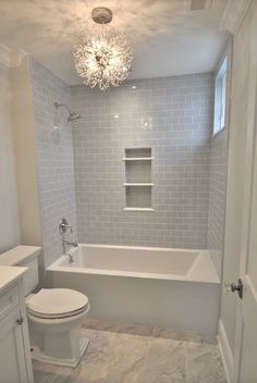 the bathroom is white and has gray tile on the walls, floor, and ceiling