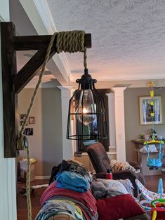 a room filled with lots of clothes and a light hanging over the top of it