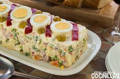 there is a cake with eggs on it and other food items next to the plate