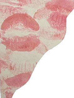 a pink and white background with red lipstick imprints on the bottom of each lip