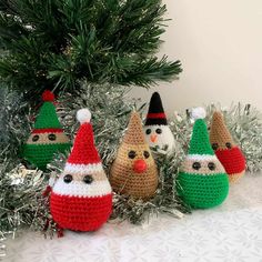 crocheted christmas ornaments are displayed in front of a tree