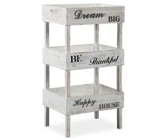 three tiered wooden shelf with words on the bottom, and one saying be happy house