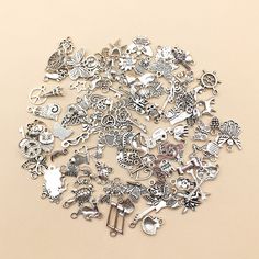 a pile of silver colored charms on a beige background with space for text or image