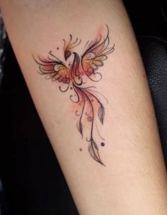 a small tattoo on the arm of a woman's left arm, with an orange bird