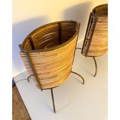 two wooden baskets sitting next to each other on top of a white flooring area