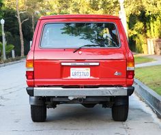 a red van parked on the side of a road