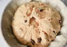 an uncooked dough in a metal bowl