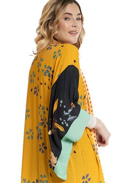 Hit the beach or kick it poolside in this flowy kaftan that features an allover floral pattern, kimono-inspired sleeves and an open-front silhouette. Kimono-inspired sleeves 100% rayon Hand wash, line dry Imported Yellow Summer Kimono For Beach Cover-up, Yellow V-neck Kimono For Vacation, Yellow Beachwear Kimono For Summer, Multicolor Relaxed Fit Kimono For Beach, Yellow Bohemian Summer Kimono, Yellow Bohemian Kimono For Summer, Yellow Summer Kimono, Relaxed Fit Multicolor Kimono For Beach, Yellow Spring Festival Cover-up