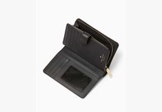 This medium wallet holds all your credit cards bills loose change i.d. receipts tickets…and it won't take up all the space in your bag. | Kate Spade Madison Medium Compact Bifold Wallet, Black Affordable Black Wallets With Interior Card Slots, Classic Black Wallets, Affordable, Cheap Kate Spade Wallets With Card Slots, Luxury Rectangular Kate Spade Wallet, Luxury Kate Spade Wallets For Daily Use, Kate Spade Outlet, Loose Change, Logo Line, Black Leather Wallet