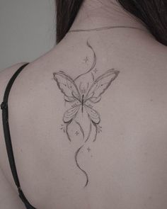 a woman with a butterfly tattoo on her back