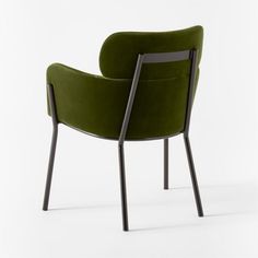 a green chair sitting on top of a white floor next to a black metal frame