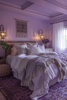 a large bed sitting in a bedroom next to a window covered in purple blankets and pillows