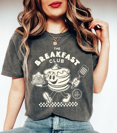 Retro The Breakfast Club Shirt, Comfort Colors Pancakes Crusher Tee, Hippie Boho Graphic T-Shirt, Funny Pancake Shirt, Breakfast Lover Gift ⭐ INFORMATION: This unisex style t-shirt is suitable for both men and women. For care, wash the item inside out in cold water. Avoid bleach, dry cleaning, and direct ironing on the design. ⭐ MATERIAL DETAILS: Our heavyweight classic unisex tee is made from 5.3-ounce, 100% cotton, with variations of 99/1 cotton/poly (Ash) & 90/10 cotton/poly (Sport Grey). It Vintage Cotton Tops For Brunch, Crew Neck Cotton Shirt For Brunch, Cotton Crew Neck Shirt For Brunch, Funny Print Graphic Tee For Brunch, Crew Neck T-shirt With Screen Print For Brunch, Screen Print Crew Neck T-shirt For Brunch, Short Sleeve Tops With Funny Print For Brunch, Funny Print Cotton Tops For Brunch, Graphic Print Crew Neck Tops For Brunch