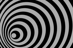 an abstract black and white background with spirals in the center, which are distorted to one another