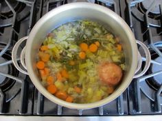 a pot filled with soup sitting on top of a stove