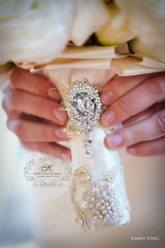 the bride's wedding bouquet is being held by her husband, who is wearing a ring