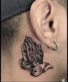 a man with a tattoo on his neck and behind the ear that has a hat