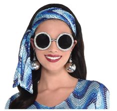 Get Groovy with these disco inspired 70's Oversized Crystal Sunglasses! These lightweight round black framed glasses with UV400 tinted plastic lenses and faux crystals are so versatile and perfect for Halloween, 70's, Elton John, rock stars, pop stars, cosplay and more! Dress, disco earrings and headscarf not included. Other costumes and accessories (earrings, theatrical makeup, GoGo boots) are sold separately on our page – subject to availability. Not designed for vision assistance or correction. One size fits most adults and teens and may fit some larger children. Disco Earrings, Retro Inspired Outfits, 70s Costume, Crystal Sunglasses, Theatrical Makeup, Gogo Boots, Rock Stars, Elton John, Glasses Accessories