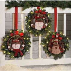 three christmas wreaths are hanging on the wall