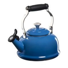 a blue tea kettle with a black handle