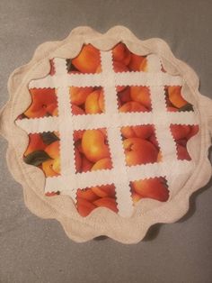 a pie plate with stamps on it that have peaches cut out and placed in squares