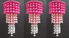 three pink and white paper lamps hanging from the ceiling