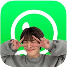 a young boy holding his hands up to his eyes with the instagram logo in the background