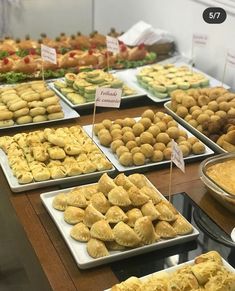 many trays of different types of food on display