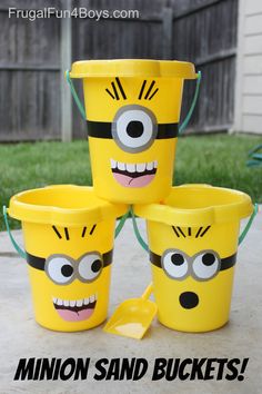 three buckets with faces painted on them and the words minion sand buckets