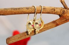 "Exquisite, antique-style very small ruby and 14k, 18k or 22k solid gold hook earrings, in an ethnic indian boho style. These amazing drop earrings have a decorated domed disc and a tiny ruby set in the middle of it. At the bottom of the disc on each earring, there are three gold dots that add character to these boho earrings. These earrings are elaborate and delicate but still very noticeable. They have a unique eye-catching boho look that will go with and upgrade any outfit. Get them as a beau Traditional 14k Gold Drop Earrings, Traditional 14k Gold Dangle Jewelry, Ceremonial Yellow Gold Round Earrings, Antique Yellow Gold Pendant Earrings, Antique Pendant Yellow Gold Earrings, Yellow Gold Pendant Earrings For Festive Occasions, Yellow Gold Pendant Earrings For Wedding, Traditional Yellow Gold Pendant Earrings, Elegant Pendant Earrings For Festivals