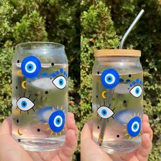 two hand painted mason jars with blue eyes