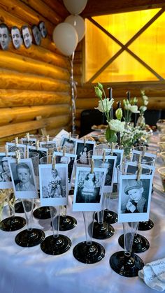 a table topped with pictures and wine glasses