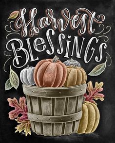 a chalkboard sign that says harvest blessing with pumpkins in a basket and leaves