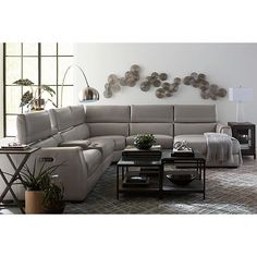 a living room with a sectional couch and coffee table