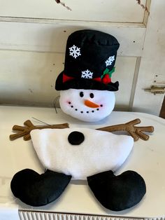 a snowman made out of felt sitting on top of a table