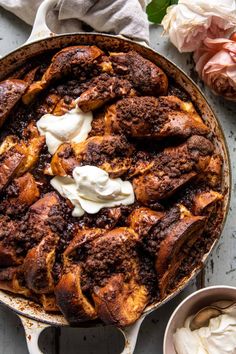 a skillet filled with bread and whipped cream