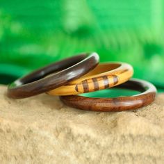 For a chic addition to your wardrobe, this set of three bangle bracelets is presented by Vipin in India. He works with local artisans, who hand-carve each bangle from mango wood. Two bracelets feature a solid hue in dark brown while the third displays a light brown hue with striped patterns. This set is perfect for wearing together or sharing with friends. Yard Sale Finds, Wooden Bracelet, India Jewelry, Jewelry Packaging, Mango Wood, Jewelry Gift Box, Bracelet Sizes, Light Brown, Leather Bracelet