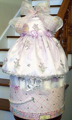 a dress and diaper on top of a wooden table in front of some stairs