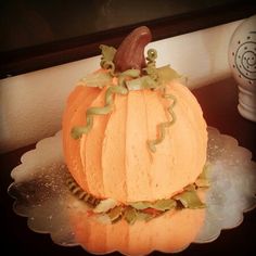 a pumpkin shaped cake sitting on top of a plate