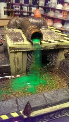 an old machine with green liquid pouring out of it